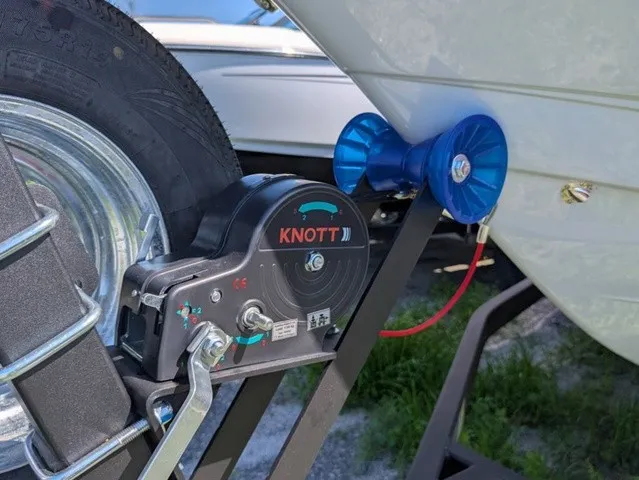 Slide: The Image of Close-up of a boat trailer with a KNOTT winch and a blue roller holder. - 3