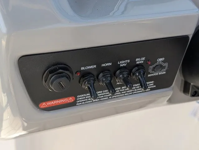 Slide: The Image of Close-up of a control panel with switches for blower, horn, lights, bilge pump, and OBD. - 22