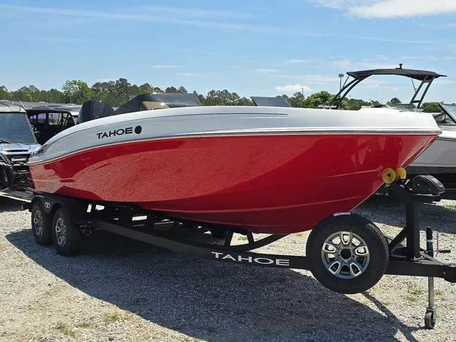 Slide: The Image of A red 2026 Tahoe T21 boat is on a trailer in a gravel lot. - 4
