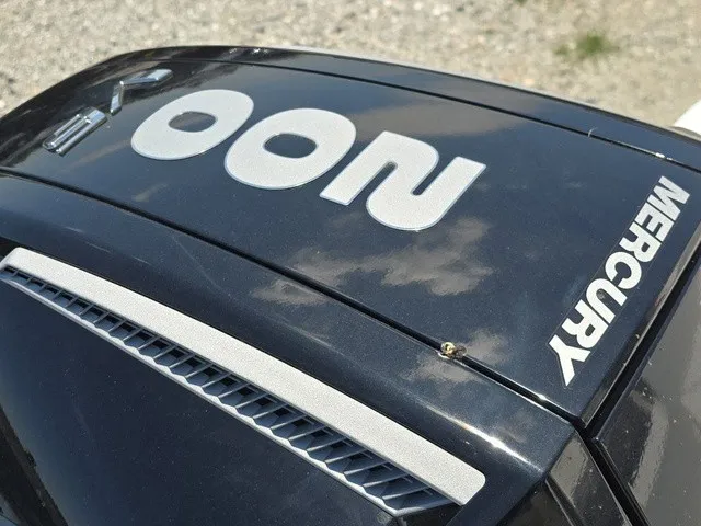 Slide: The Image of Close-up of a Mercury engine cover detail with reflective lettering. - 10