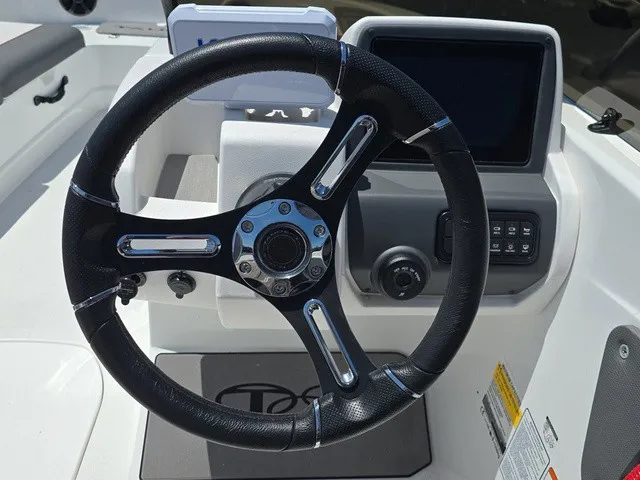 Slide: The Image of The image shows the helm of a 2026 Tahoe T21 boat with a modern dashboard. - 22
