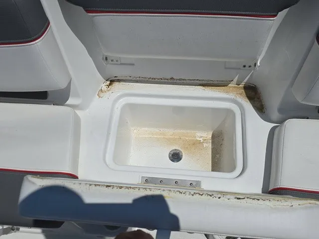 Slide: The Image of An open storage compartment on a boat with a slightly dirty edge. - 26