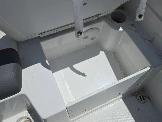 Slide: The Image of An open storage compartment on a boat with gray and white surfaces. - 28