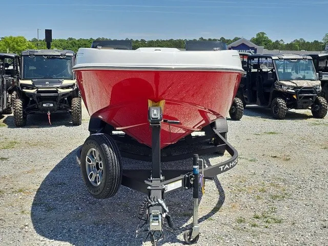 Slide: The Image of A red 2026 Tahoe T21 boat sits on a trailer in a gravel lot. - 3