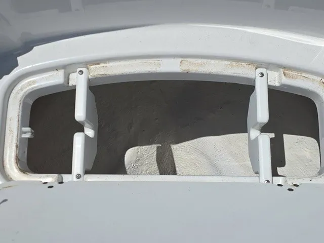 Slide: The Image of Close-up of a white boat part with rectangular cutouts and screws. - 14