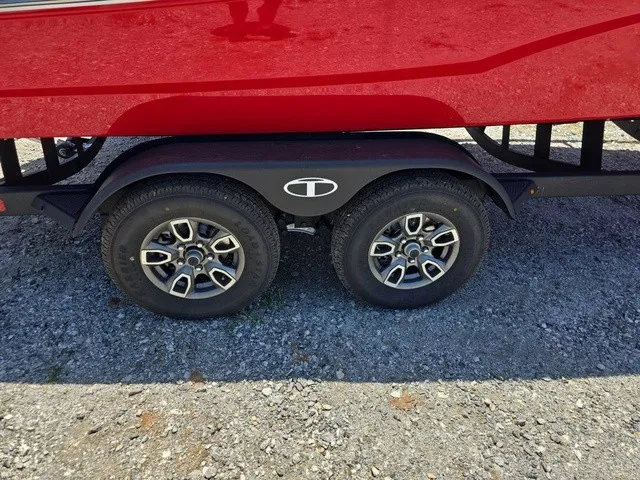 Slide: The Image of Close-up of a boat trailer with two wheels and a red boat on it. - 30