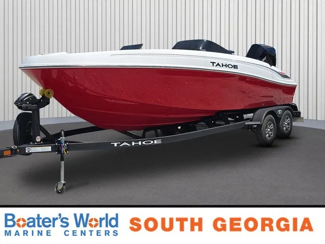 The Image of 2026 Tahoe T21 boat on a trailer in a showroom. - 1