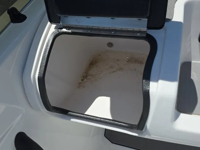 Slide: The Image of An open storage compartment on a boat with a slightly dirty bottom. - 18