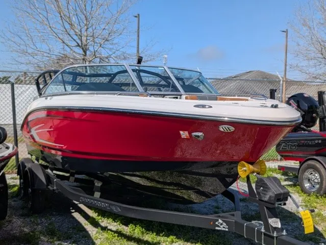 Slide: The Image of A red 2023 Chaparral 21 SSi boat is on a trailer outdoors. - 8