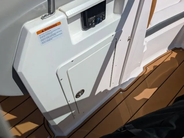 Slide: The Image of Interior view of a 2023 Chaparral 21 SSi with wood flooring and control panel. - 33
