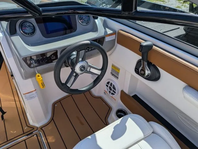 Slide: The Image of The cockpit of a 2023 Chaparral 21 SSi with a modern steering wheel and digital dashboard. - 22
