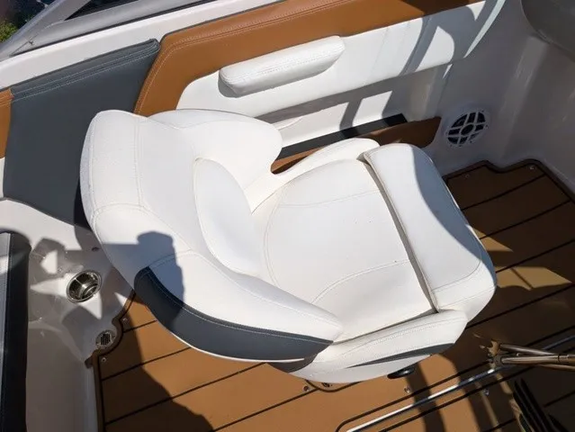Slide: The Image of A white cushioned boat seat with brown and gray accents on a wooden deck. - 30