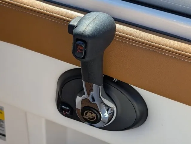 Slide: The Image of Close-up of a throttle lever in a Chaparral 21 SSi boat, featuring brown and white trim. - 28
