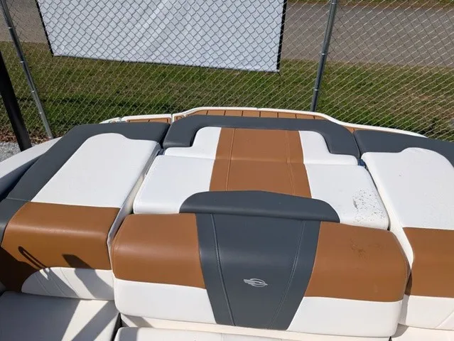 Slide: The Image of The rear of a Chaparral 21 SSi boat with cushioned seats in white, brown, and gray. - 20