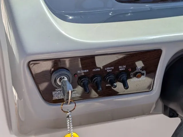 Slide: The Image of Close-up of a Chaparral 21 SSi dashboard with switches and ignition key. - 26