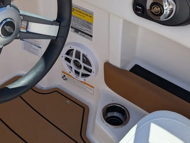 Slide: The Image of Close-up of a 2023 Chaparral 21 SSi cockpit with steering wheel and speaker. - 23