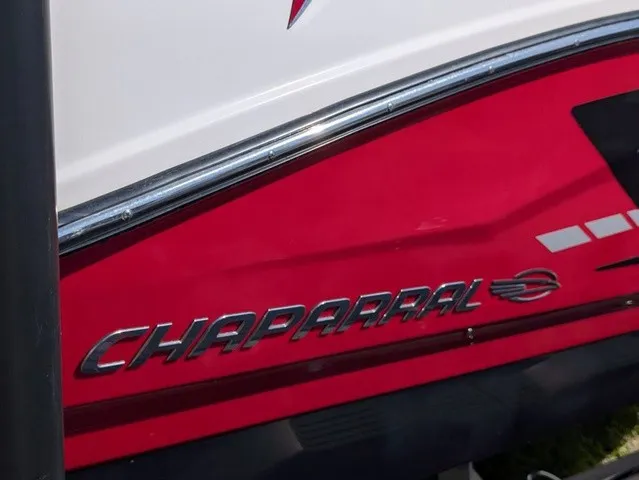 Slide: The Image of Close-up of a red hull on a Chaparral 21 SSi boat with silver logo. - 15