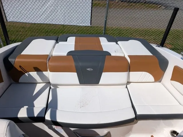 Slide: The Image of The seating area of the 2023 Chaparral 21 SSi features white, brown, and gray upholstery. - 19