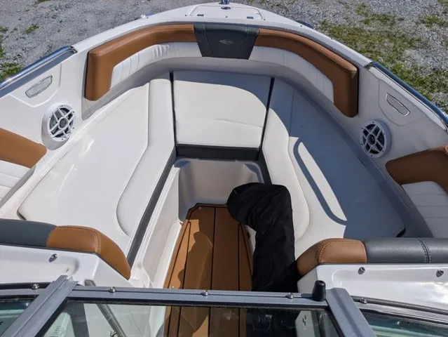 Slide: The Image of The image shows the bow area of a 2023 Chaparral 21 SSi with white and brown upholstery. - 32