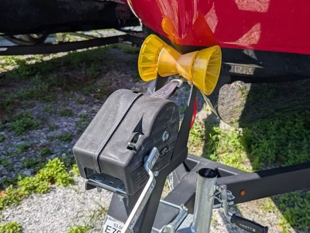 Slide: The Image of Close-up of a boat trailer with a yellow bow roller and a black winch. - 6