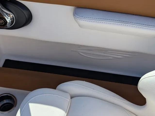 Slide: The Image of Close-up of a white seat with brown accents in a boat. - 24