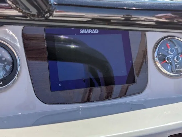 Slide: The Image of The image shows a Simrad display on the dashboard of a Chaparral 21 SSi boat. - 25