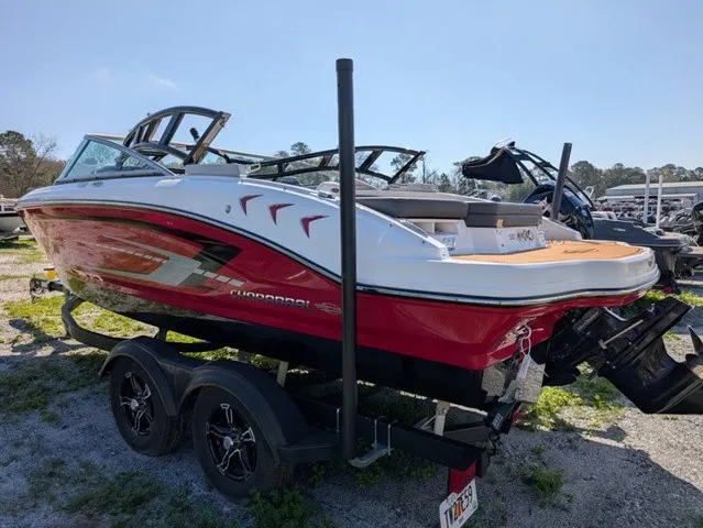 Slide: The Image of A red 2023 Chaparral 21 SSi boat on a trailer, ready for the water. - 12