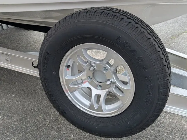 Slide: The Image of Close-up of a boat trailer wheel with a silver rim and black tire. - 6