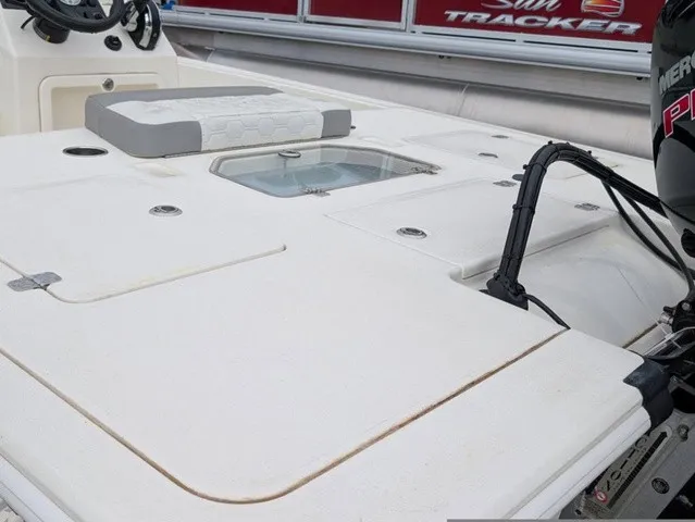 Slide: The Image of The image shows the deck of a Mako 18 Pro Skiff boat with an engine in the background. - 17
