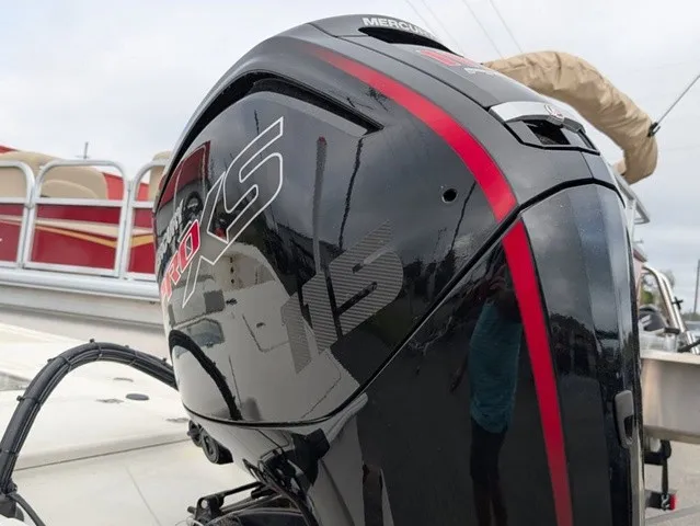Slide: The Image of A black outboard motor with red accents is mounted on a boat. - 15