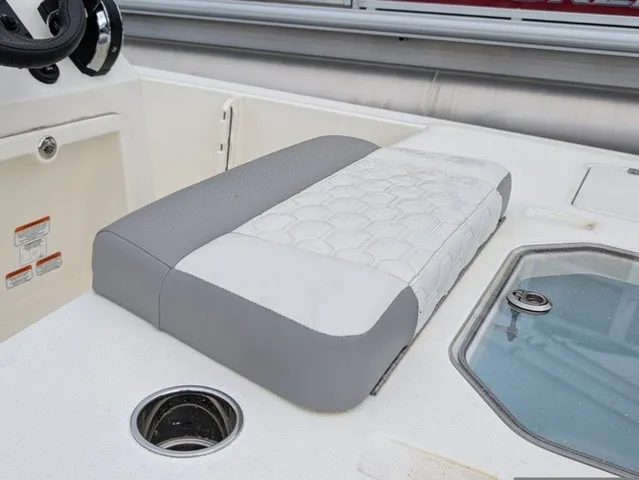 Slide: The Image of The image shows a bench seat on a Mako 18 Pro Skiff boat with gray and white upholstery. - 19