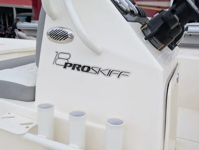 Slide: The Image of Close-up of a Mako 18 Pro Skiff console with cup holders and controls. - 20