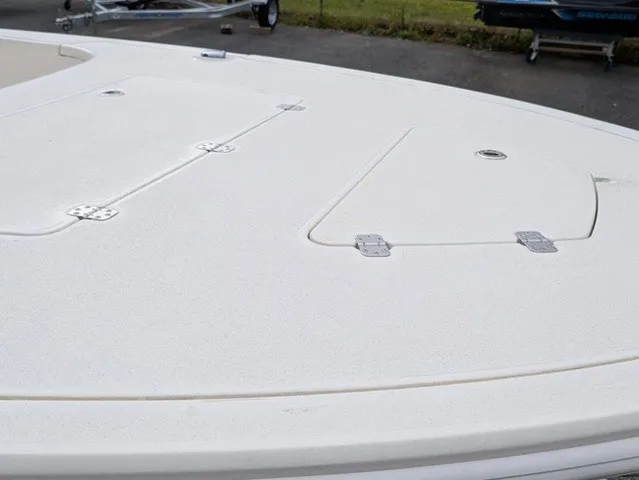 Slide: The Image of The image shows the deck of a Mako 18 Pro Skiff boat with multiple hatches. - 7