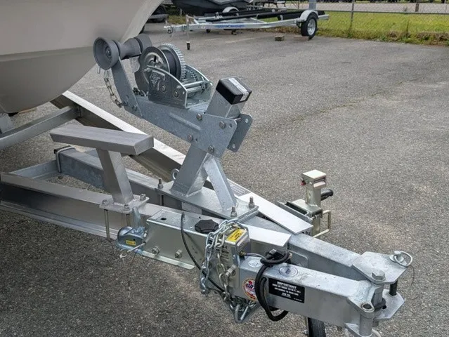 Slide: The Image of A boat trailer with a winch and safety chains on a parking lot. - 5
