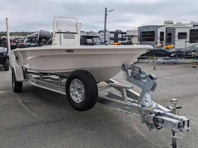 Slide: The Image of A 2026 Mako 18 Pro Skiff on a trailer, surrounded by RVs and vehicles. - 4