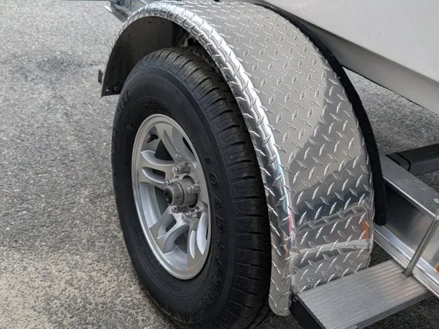 Slide: The Image of Close-up of a boat trailer with a sturdy tire and diamond-patterned fender. - 11