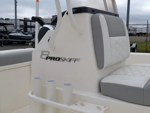 Slide: The Image of Close-up of a 2026 Mako 18 Pro Skiff interior with gray and white seating. - 9