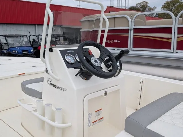 Slide: The Image of The image shows the helm of a 2026 Mako 18 Pro Skiff with gray seating. - 18
