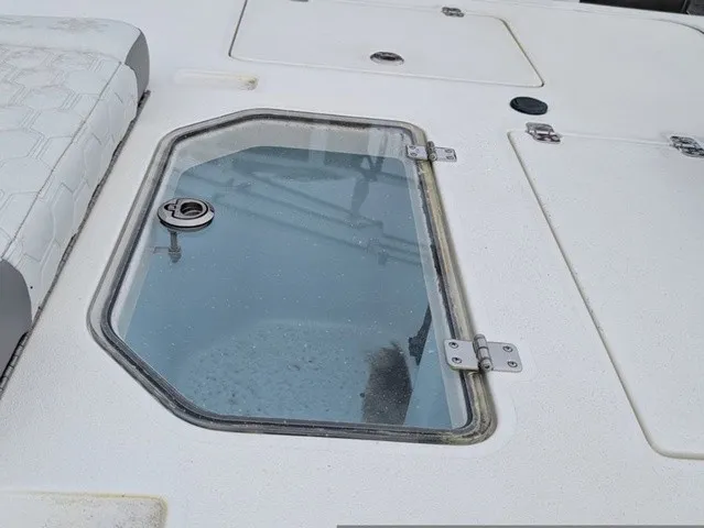 Slide: The Image of The image shows the deck of a Mako 18 Pro Skiff with a glass window and seat cushion. - 23