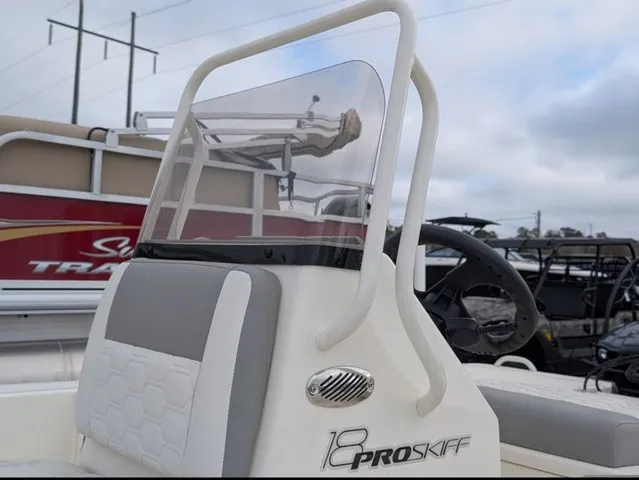 Slide: The Image of The image shows the helm of a Mako 18 Pro Skiff with a windshield and steering wheel. - 22