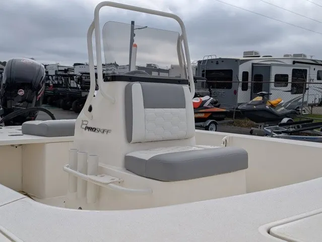 Slide: The Image of The image shows a Mako 18 Pro Skiff boat with gray and white seating and a helm console. - 8