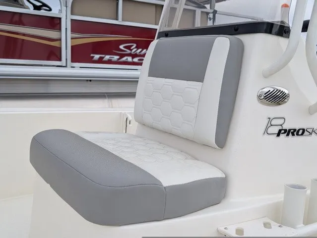 Slide: The Image of The image shows the seat of a 2026 Mako 18 Pro Skiff with gray and white upholstery. - 21