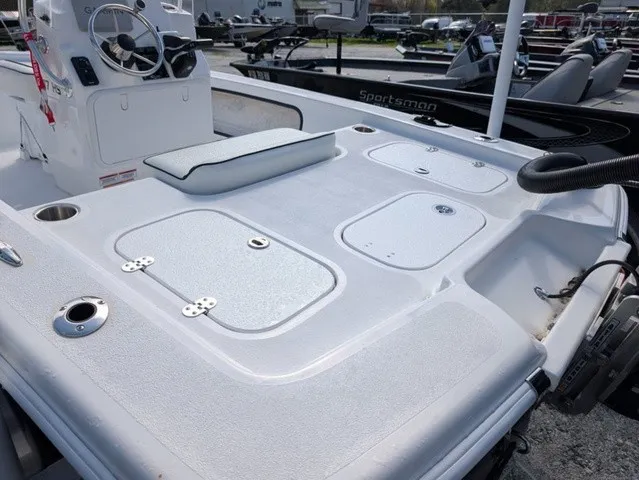 Slide: The Image of The image shows the deck of a 2025 ALK2 Powerboats 17 HS with storage hatches and a helm console. - 16