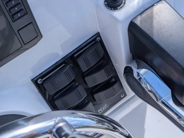 Slide: The Image of Close-up of a boat's helm with switches and a shiny lever. - 25