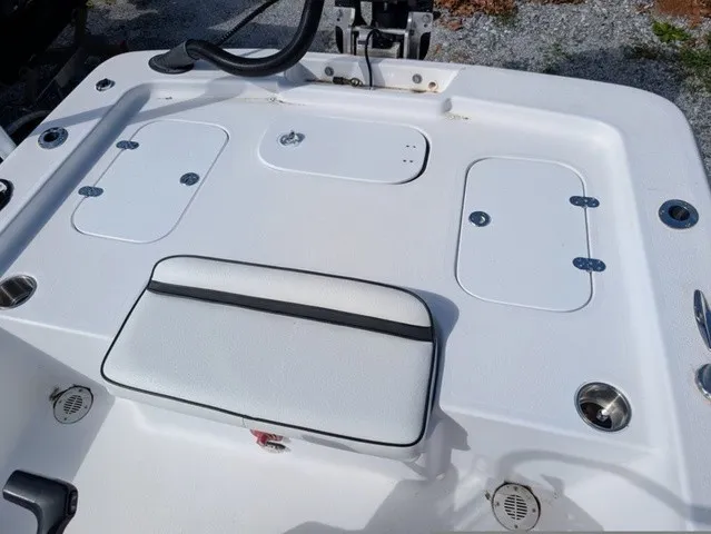 Slide: The Image of The image shows the white stern of a boat with multiple storage compartments and a cushioned seat. - 27
