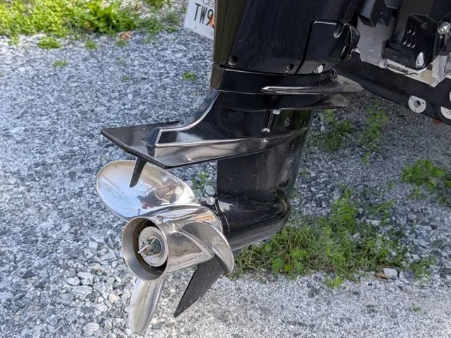 Slide: The Image of Close-up of a shiny outboard motor with propeller on gravel ground. - 13