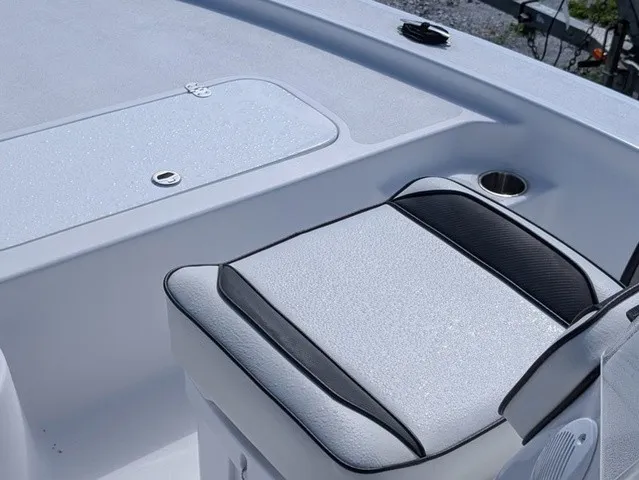 Slide: The Image of The image shows a seating area on a boat with a cushioned seat and storage underneath. - 22