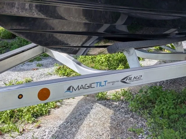 Slide: The Image of A boat on a trailer labeled "Magic Tilt" and "ALK2 Powerboats." - 3