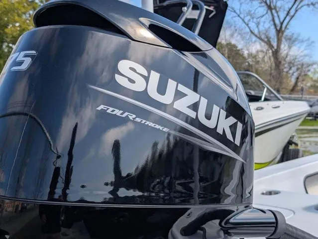 Slide: The Image of Close-up of a Suzuki four-stroke outboard motor on a boat. - 11