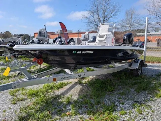 Slide: The Image of A modern motorboat on a trailer, surrounded by other boats and a fence in the background. - 2